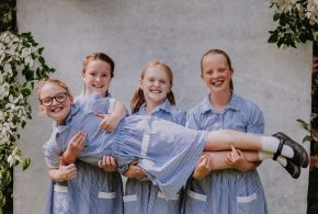 Maynard-School-2024-student-group-3-girls-holding-up-4th